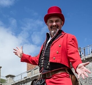 Picture of Kevin Burke dressed as a circus performer.